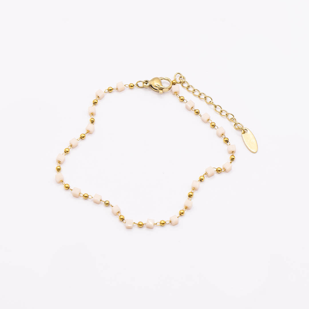 Bransoletka z beżowymi koralikami pozłacana ze stali