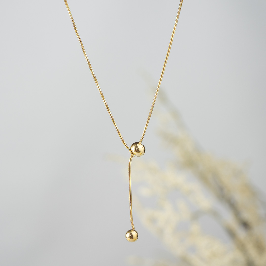 Naszyjnik krawatka z kulkami pozłacana stal szlachetna